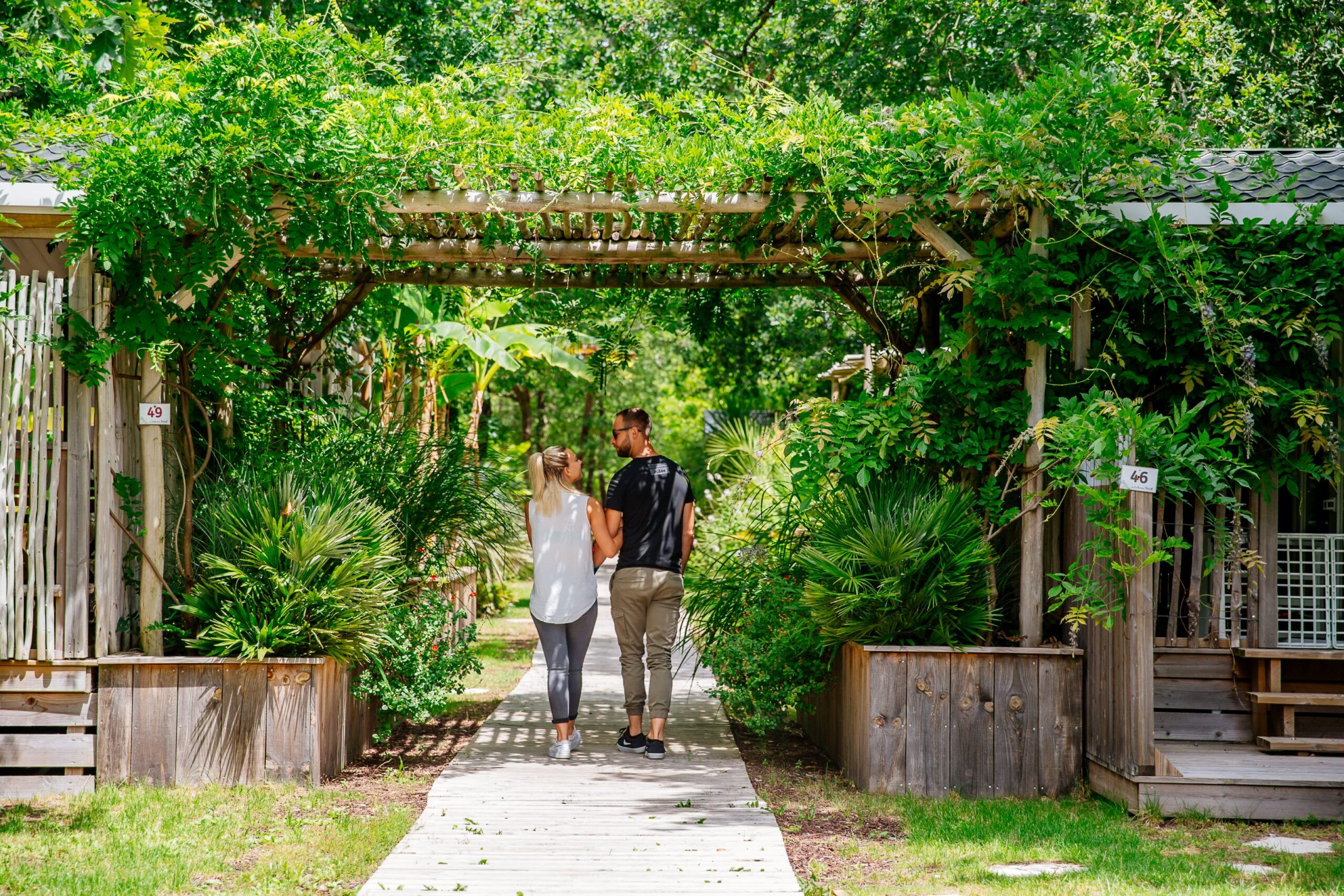 Un couple se promène au camping Aux Couleurs Du Ferret.